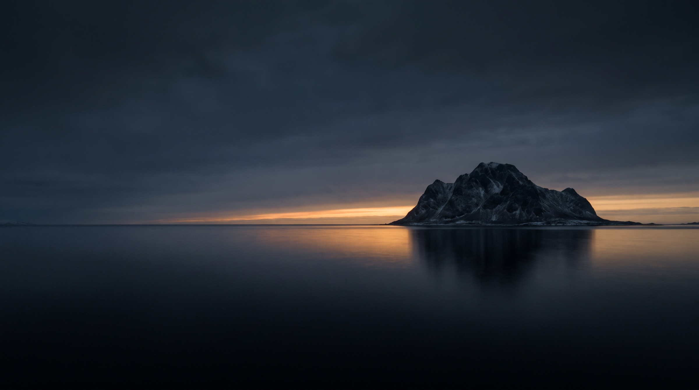 First light on the horizon behind the island